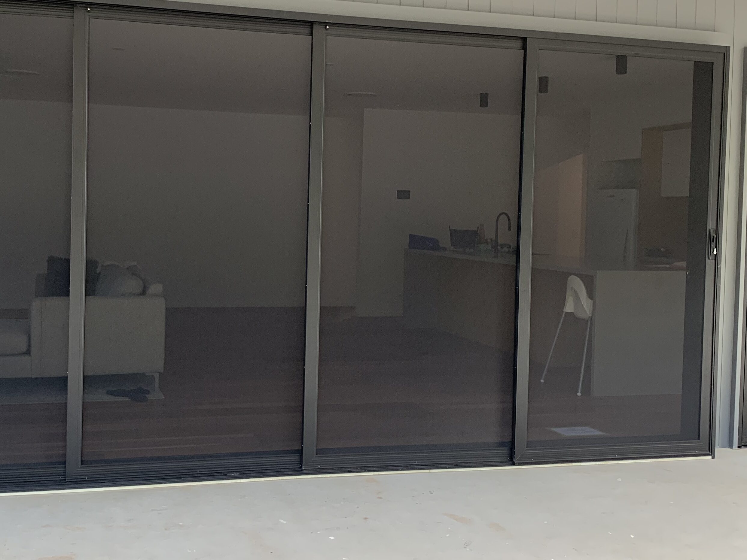 Four-panel SecureView stacking security doors on a modern Sunshine Coast home