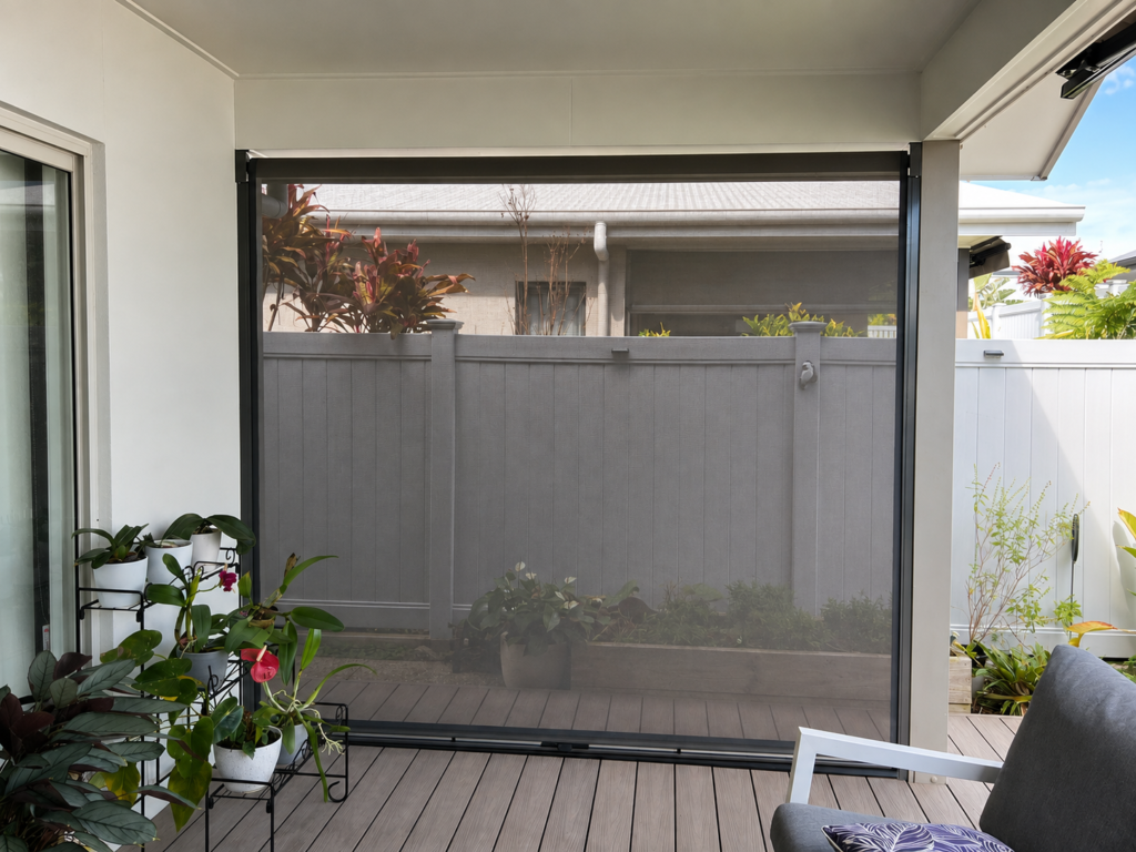A smaller spring-operated Ziptrak blind installed without a pelmet, leaving the roller visible at the top